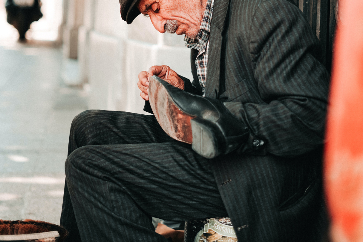 old man shining shoe