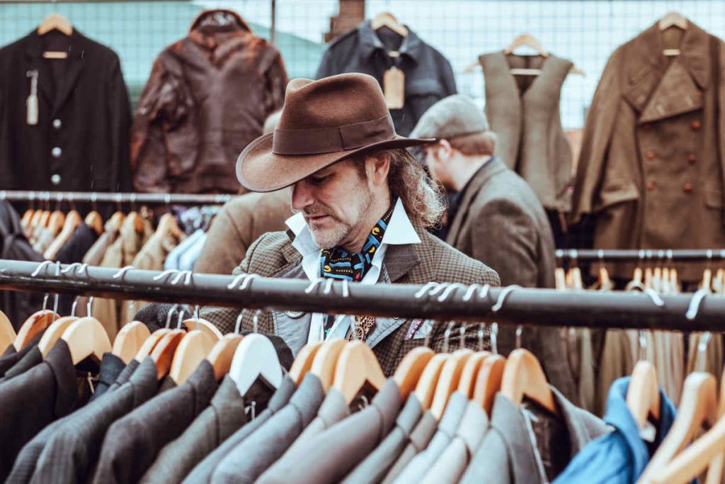 Man picking tailored jackets from a rack