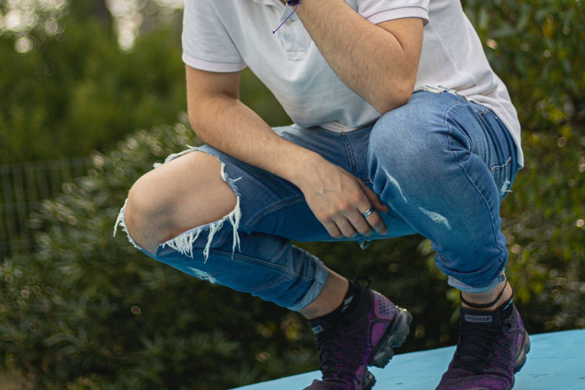 badly dressed man crouching