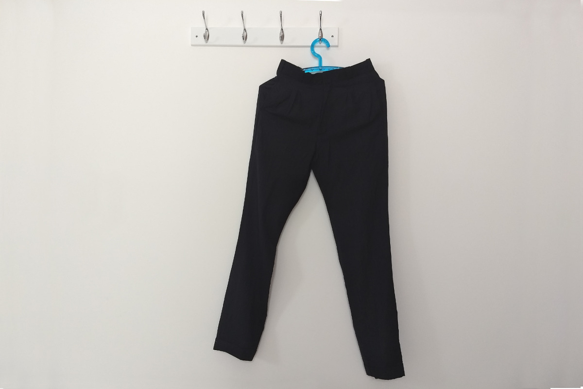 Dark navy trousers hung on the wall