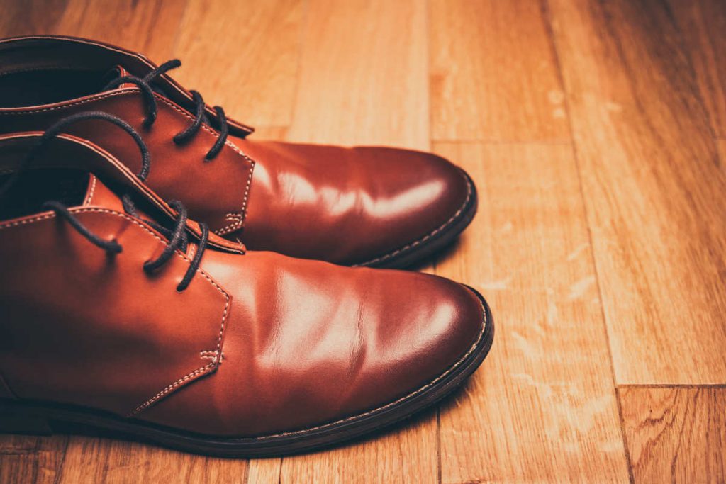 Profile view of a pair of brown derby boots