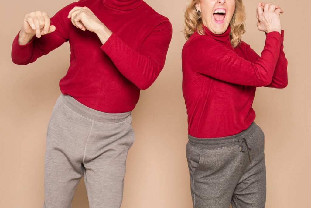 Couple wearing matching sweatpants and red sweaters