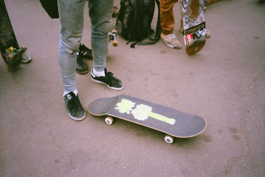 Skater next to a broken skateboard