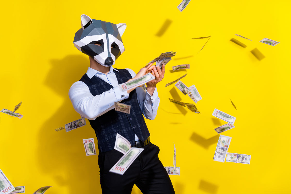 Photo of crazy bizarre authentic guy racoon mask waste billion dollars lottery win jackpot isolated over shine yellow color background